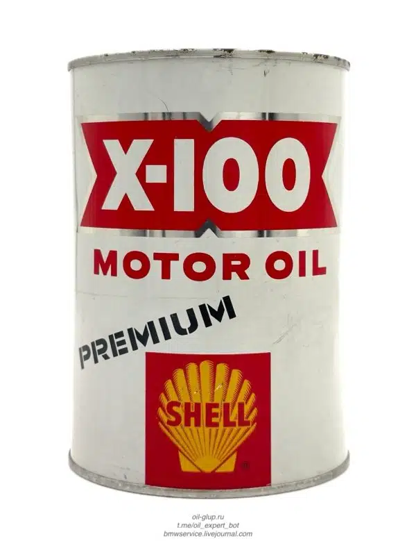 Белая банка моторного масла Shell X-100 с логотипом ракушки и надписью Premium на красном фоне.
