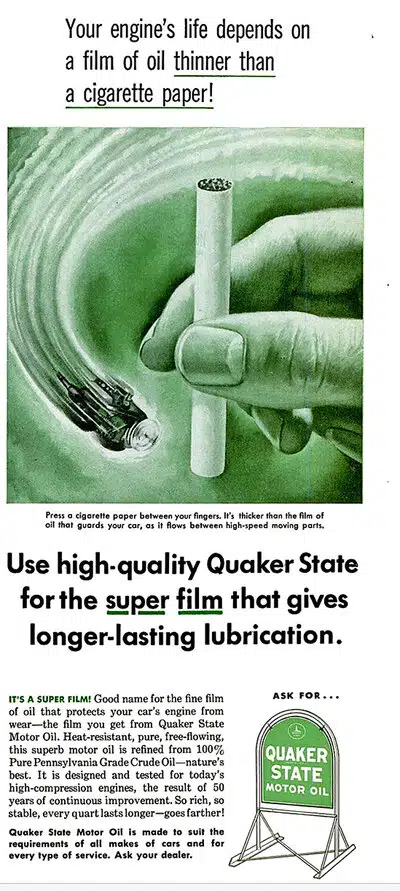 Винтажная реклама Quaker State Motor Oil показывает руку с сигаретой и масло защищающее двигатель авто.