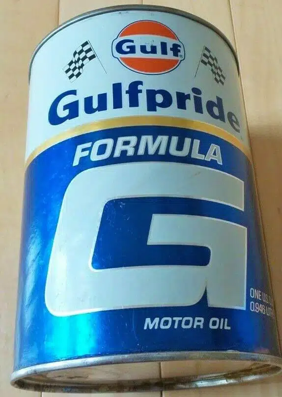 На фото металлическая банка моторного масла Gulfpride Formula с логотипом Gulf и гоночными флагами.