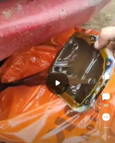 На фото масло темного цвета в поддоне рядом с красной поверхностью и оранжевой тканью.